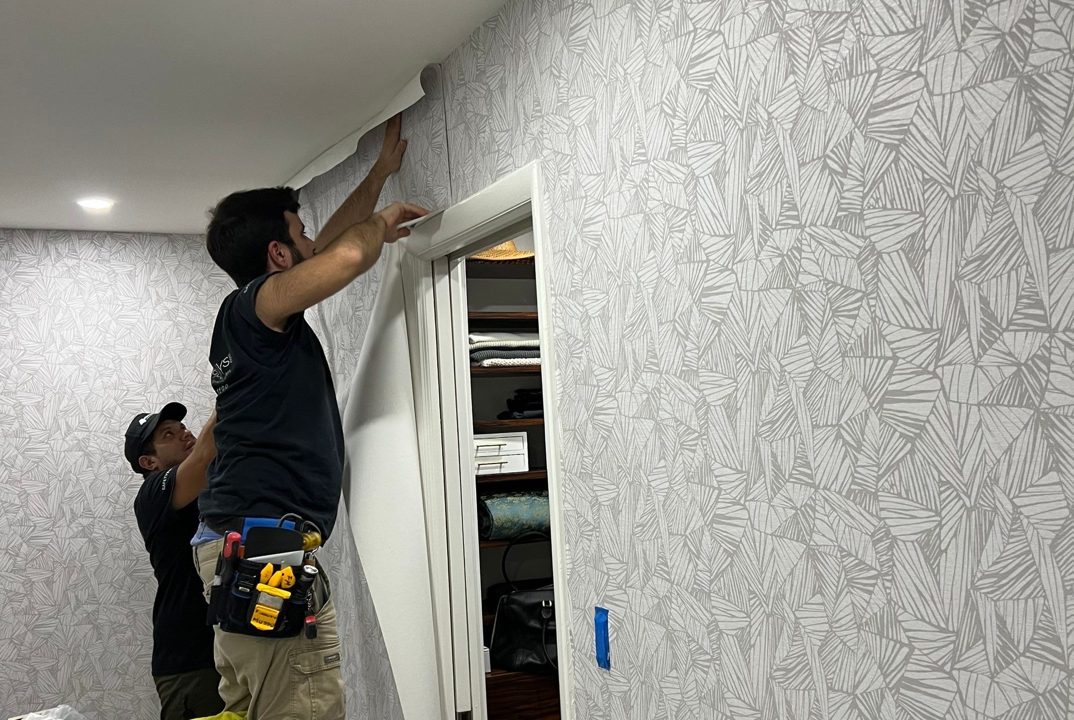 Professional wallpaper installer at work